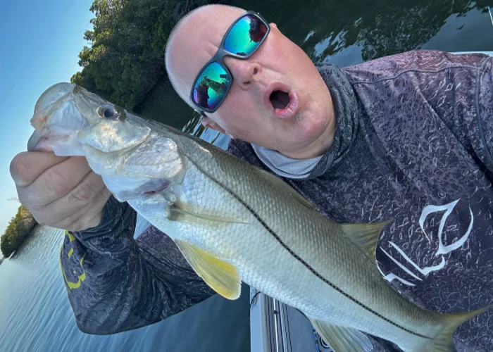 Captain Mike Boyles holding a bass during a guided fishing trip