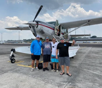 The group gathered beside a small plane for an Amazon fishing expedition