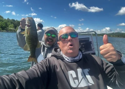 Anglers celebrate a successful bass catch on the water