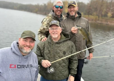A group of anglers standing together on a fishing boat