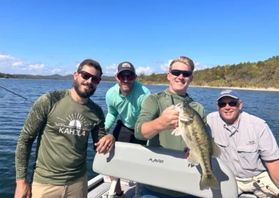 Group of anglers holding bass during a guided fishing trip
