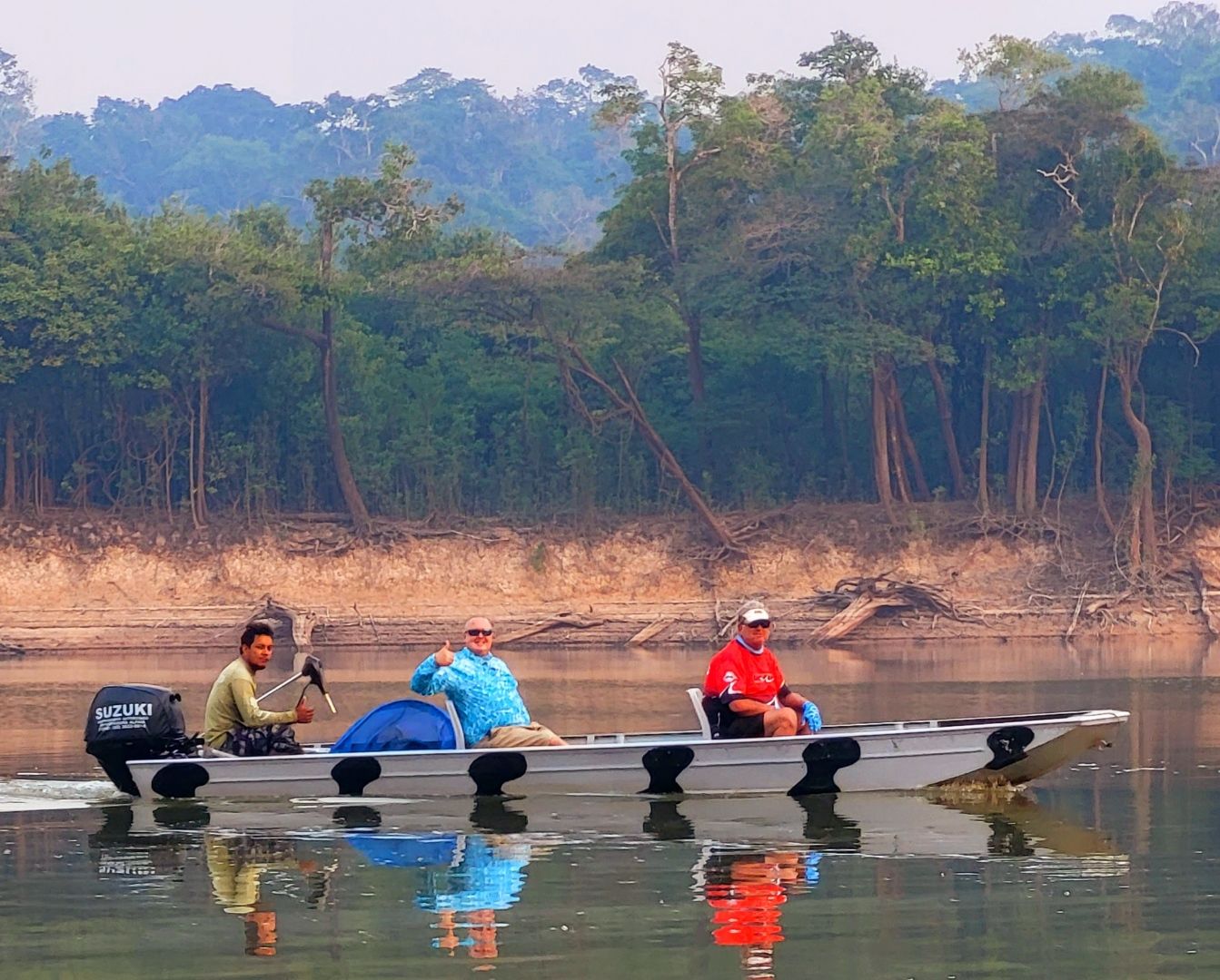 Mike Boyles and guests riding a small boat on the Amazon River